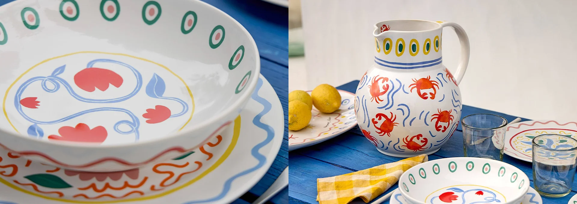 Colorful hand-painted ceramic dishware, including bowls, plates, and a crab-patterned pitcher, on a blue wooden table.