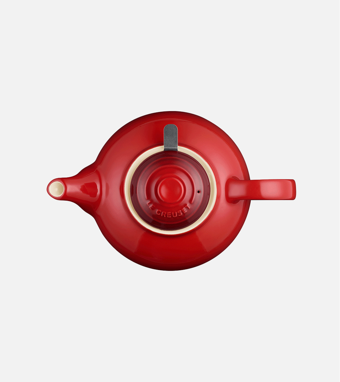 Top-down view of a red ceramic teapot with a handle, spout, and a lid with concentric circles.