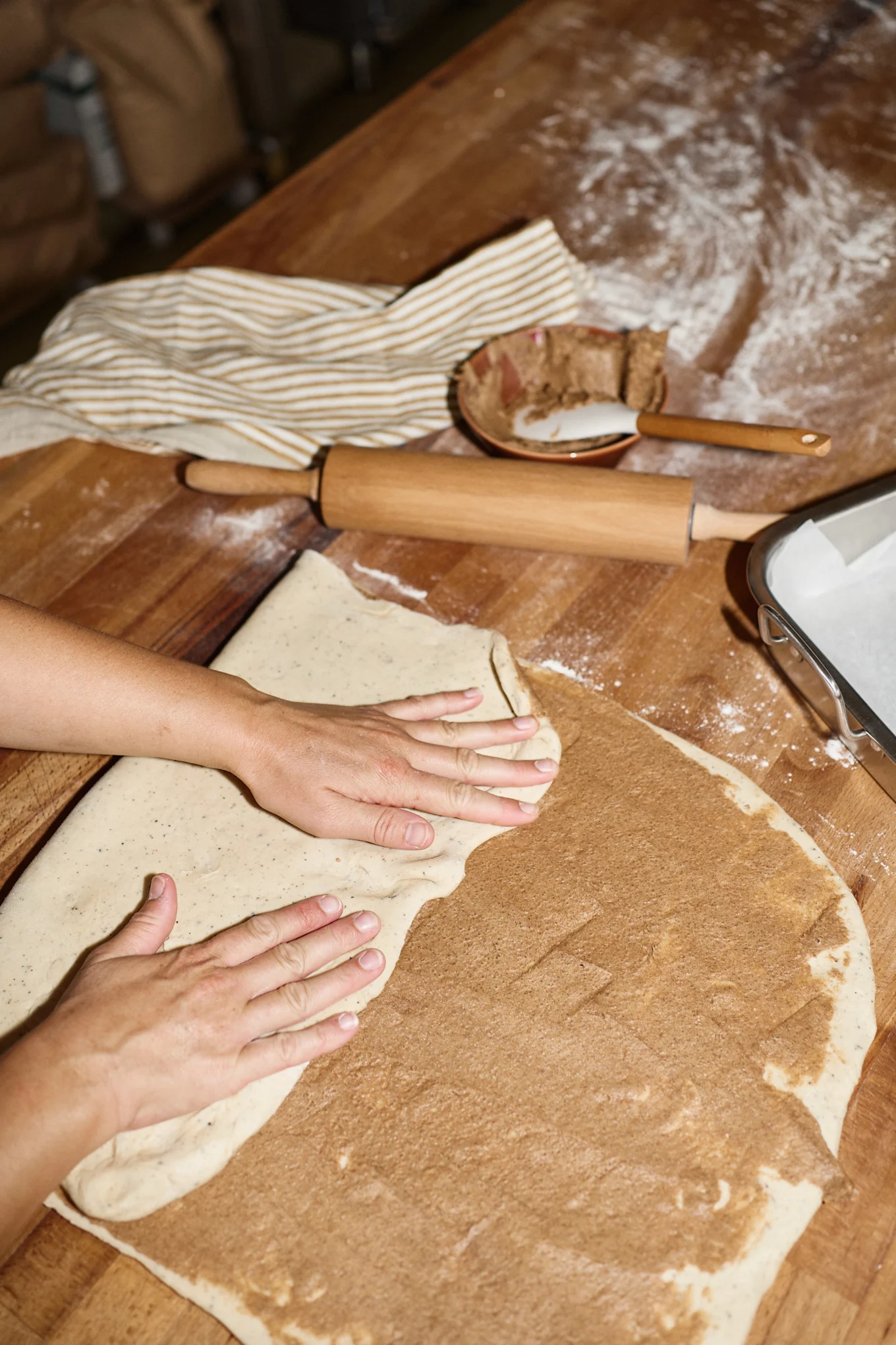 After Lilian has rolled out her dough and spread it with the butter and sugar mixture, she folds it several times to mix everything together.