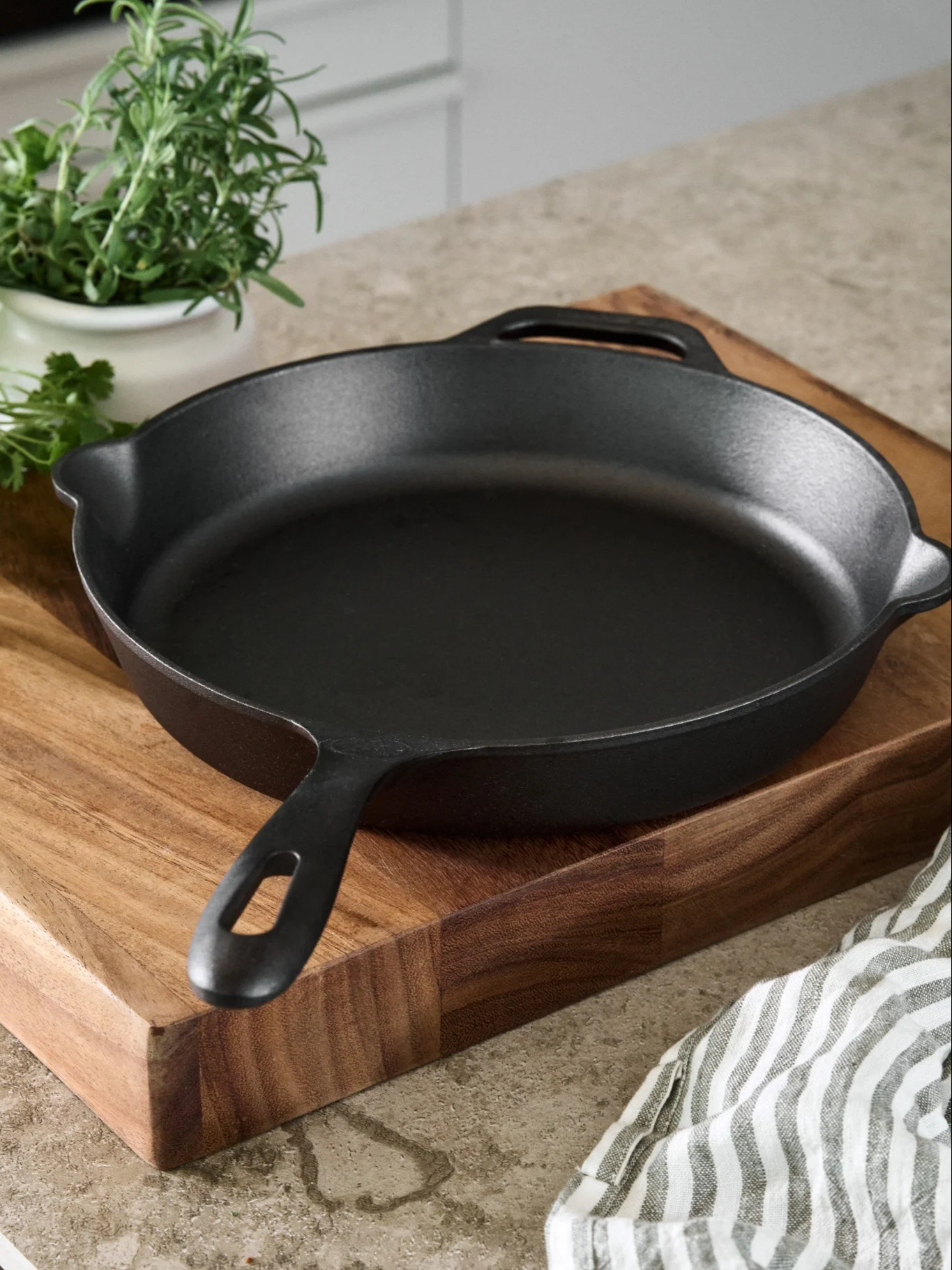 Cast iron pan from Victoria cookware on a wooden cutting board. 